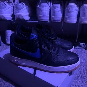 Black and blue Nike Air Force peanut butter bottoms.